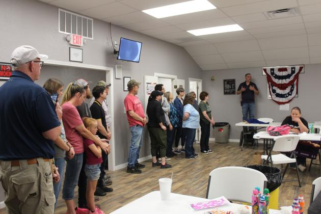 The family of Tom Combs listens during the bingo hall rededication.