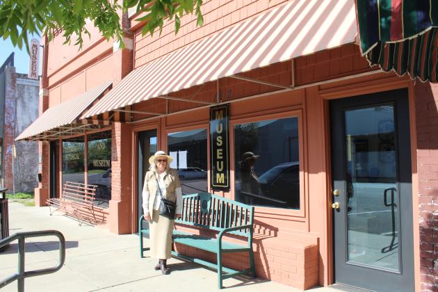 Tecumseh Historical Society member Arthenia Haney stands in front of the updated facade, including awnings, of the Tecumseh Museum on April 11. Natasha Dunagan, Countywide &amp; Sun