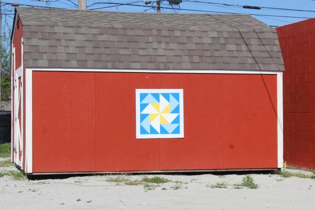 A Barn Quilt square created by volunteer Randy Swinson is on display on a shed behind the Tecumseh Museum.