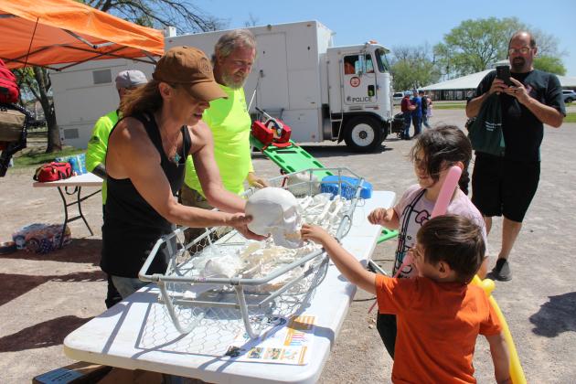 Magen Drake and Director Brian Smith of OKC Metro Search &amp; Rescue teach two children about the bones of the body.