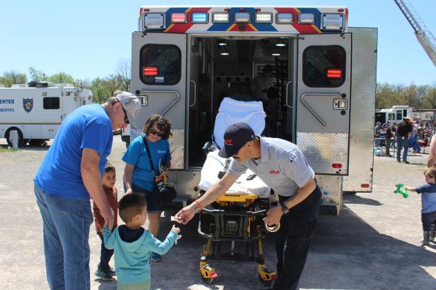 Paramedic Jake Shirey with Shawnee REACT hands out stickers.