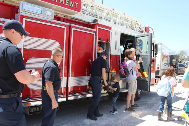 Shawnee Firefighters Dillon McCabe, Denis Taron and Cody Tate give stickers and talk with children and parents
