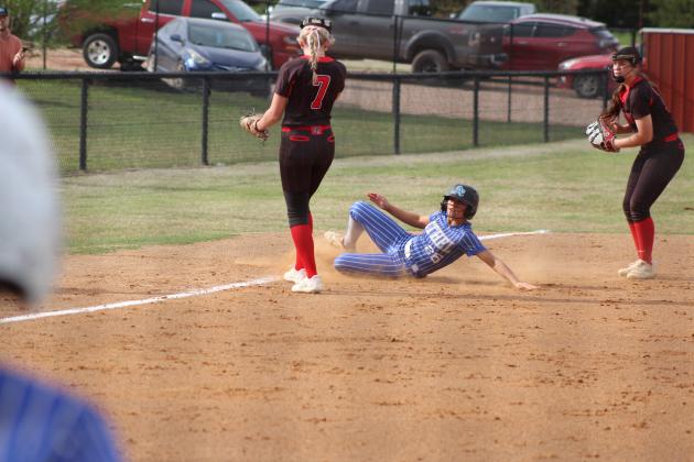Bailey Tucker slides into third base.