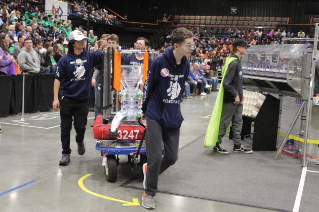 Shawnee High School's Robopack pulls their robot, the "USS Octobot," to their pit area after a playoff match on April 5 during the Oklahoma Regionals FIRST Robotics Competition at FireLake Arena. Shown, from left, are Jun Gao, Gabe Tribble, Michael Buchanan and Casen Peters. Natasha Dunagan, Countywide &amp; Sun