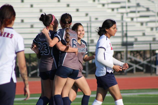 Shawnee senior Kalieo Citizen (#23) is congratulated by her teammates after making a goal during the April 8 home game with Nathan Hale. The Lady Wolves won, 10-0. Natasha Dunagan, Countywide &amp; Sun