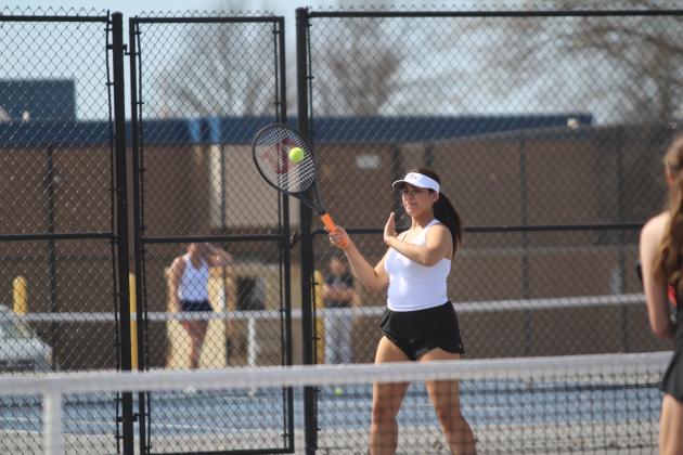 Shawnee senior Emelia Bronson returns the ball during the East/West Quad Tournament on March 25. Bronson is on the #1 Doubles team with senior Emma Hitt. Natasha Dunagan, Countywide &amp; Sun