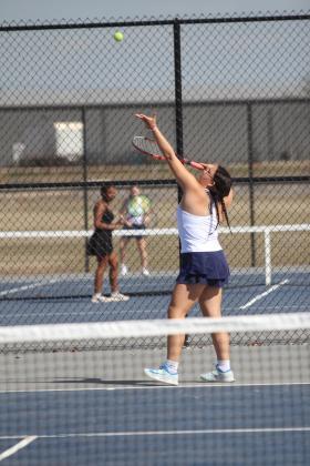 Shawnee senior Daisy Meeks serves in #1 Singles against Elgin during the East/West Quad Tournament on March 25. Natasha Dunagan, Countywide &amp; Sun