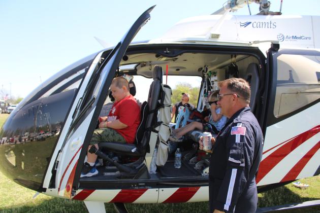 Air EVAC Lifeteam Pilot Mike Koval answers questions from Nicholas Medley, 6, of Shawnee, as his sister, Emmerlie, 3, sits in the back of the 2024 EC130 helicopter during the Touch A Truck and Beyond event, held at the Citizen Potawatomi Nation Festival Grounds on April 12. Koval said their company, out of Seminole, has invested in all the latest safety equipment, including auto pilot, air intake system, three GPSs, and traffic avoidance system.