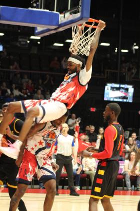 Potawatomi Fire Guard and Forward Jachai Simmons hangs from the basket after making a slam dunk in the April 26 home game against the St. Louis Griffins. The Fire won 127-124, in overtime. Natasha Dunagan, Countywide &amp; Sun