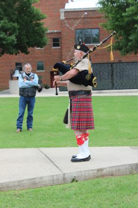 Tim Abdon, with the Scottish American Military Society in OKC, plays "Flowers of the Forest" on the bagpipes at Woodland Veterans Park in Shawnee for the Fifth Annual Gold Star Families Memorial Ride on May 24. Abdon said the song commemorates the Battle of Flodden, where the Scottish King James IV died along with most of his men, and is only played at military ceremonies. Natasha Dunagan, Countywide &amp; Sun