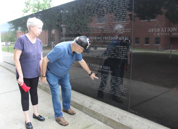 Linda and David Hendrickson point out where their son's name is on the Oklahoma Veterans Memorial Wall at Woodland Veterans Park in Shawnee during the Fifth Annual Gold Star Families Memorial Ride on May 24. Their son, Robert T. Hendrickson, was the last one killed in his unit during Operation Iraqi Freedom on Feb. 1, 20 years ago. Natasha Dunagan, Countywide &amp; Sun