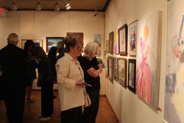 Artist Lynn Pollei looks over the donations for "Off the Wall."