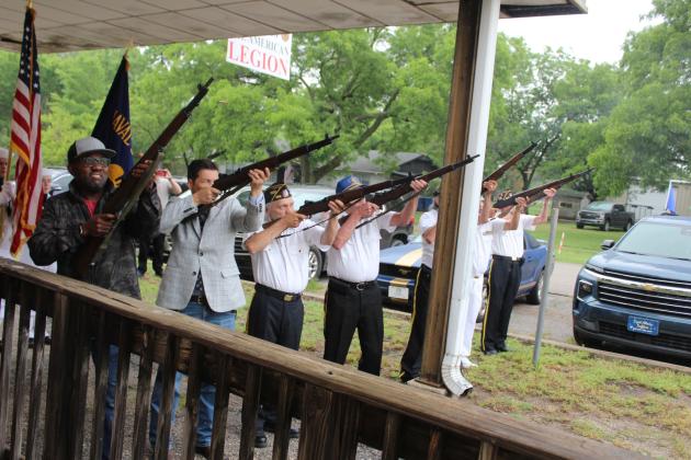 The American Legion Post 260 Honor Guard and a few volunteers give a 21-gun salute during the Memorial Day Ceremony in Tecumseh on May 26. They are, from left, Ignacio "Z" Zidor, OK Sen. Shane Jett, Stuart Rose, Alan Stewart, Bill Gammage (partly hidden by post), Roy Wano and Henry Watters. Natasha Dunagan, Countywide &amp; Sun