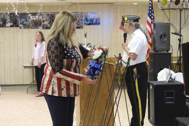 Sandray Roberts places a wreath for the Space Force at the American Legion Post 260 Memorial Day Ceremony on May 24. Others in the Auxiliary also placed wreaths for the Army, Navy, Marines, Air Force, Coast Guard, Gold Star Families and Merchant Marines. Natasha Dunagan, Countywide &amp; Sun