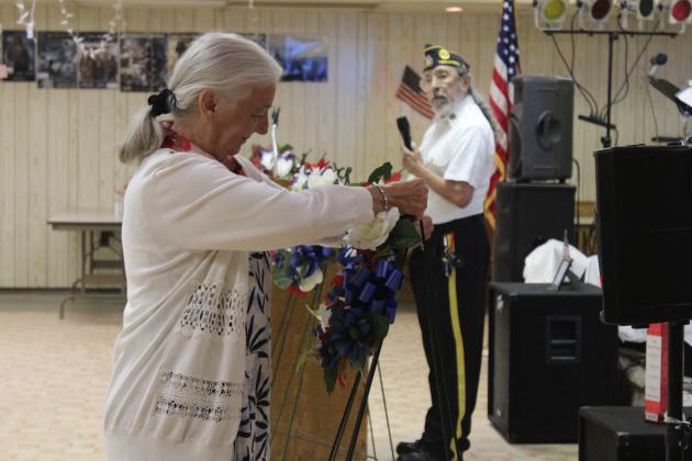 American Legion Post 260 Auxiliary member Carolyn Rose places a wreath for the Merchant Marines, as Post Adjutant William Gammage looks on, during the Memorial Day Ceremony in Tecumseh on May 26 Other Auxiliary members placed wreaths for the Army, Navy, Marines, Air Force, Space Force, Coast Guard and Gold Star Families. Natasha Dunagan, Countywide &amp; Sun