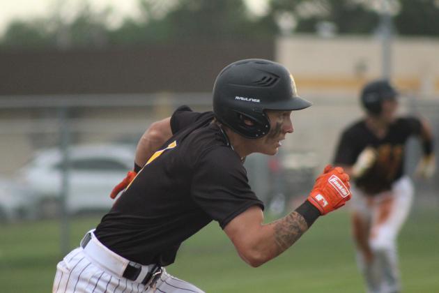 Tecumseh senior Zant Shirey runs to first after hitting a single in the seventh inning of the Senior Night home game against Chandler on April 28. The Savages won, 11-9, in their last regular season game.