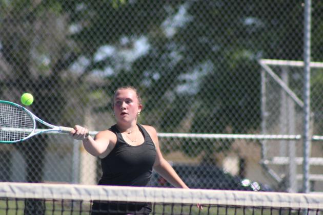 Tecumseh's Kalyn Bartmess, on #2 Doubles with Lili Lowden, makes a forehand stroke during a triangular meet with Skiatook, on the morning of April 21. Tecumseh played Byng that afternoon. Both boys and girls won against Skiatook and lost to Byng in all divisions. Natasha Dunagan, Countywide &amp; Sun