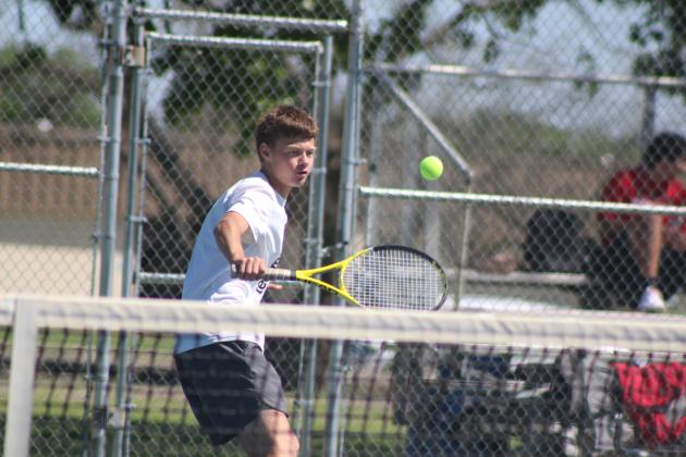 Tecumseh freshman Jett Jeffcoat makes a backhand stroke during a triangular meet with Skiatook, on the morning of April 21. Tecumseh played Byng that afternoon. Both boys and girls won against Skiatook and lost to Byng in all divisions. Natasha Dunagan, Countywide &amp; Sun