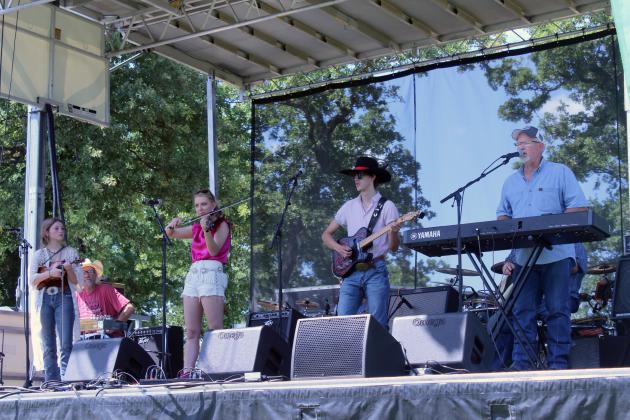 The McKedys, including Sienna Rose, Byron McKedy, Mackynsie McKedy, Austin McKedy and Jason Baird, perform at the McLoud Blackberry Festival on June 21. The temporary stage they played on was rented, but there is a smaller permanent stage in the southern half of McLoud's Veterans Park where the festival was held this year, said Melanie Krause with the McLoud Chamber of Commerce.