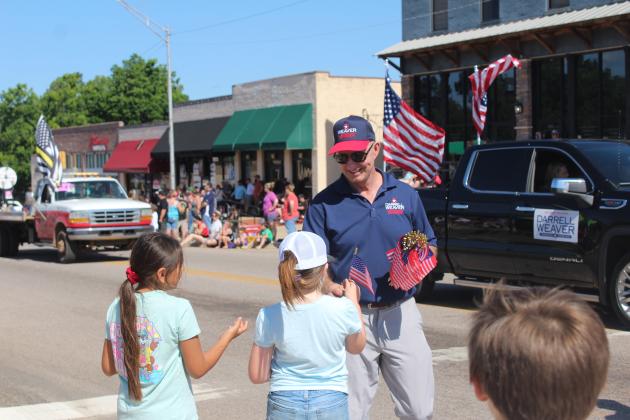 State Senator Darrell Weaver, who is running for Oklahoma Lieutenant Governor, hands out flags during the McLoud Blackberry Festival Parade on June 21.
