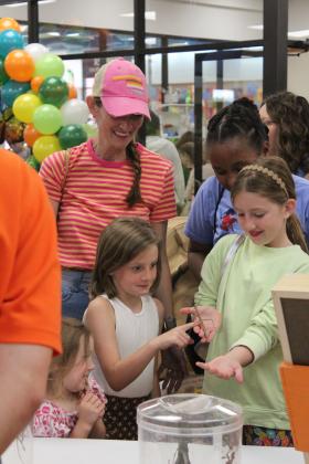 Matilda Geiger, 4; Vivian Geiger, 8; Cecelia Geiger, 10; their mother Rachael Geiger; and Nadine Nsabimana, all of Shawnee, enjoy a moment with a walkingstick during Bugfest at Shawnee Public Library on May 31. Entomologist Neil Aker was in charge of the OSU Insect Adventure where kids and adults could pet or hold insects and arachnids of all kinds. Natasha Dunagan, Countywide &amp; Sun