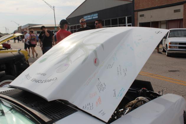 About 65 signatures cover the hood of a 1991 Ford Foxbody Mustang which belonged to the late Christopher Stone of Earlsboro. Stone's father, Michael Stone, said he held a get together for his son's friends after his passing three years ago, and he may need to have another signing event, as some of the autographs have faded. The car could be seen at the Downtown Auto at Sundown Car Show in Shawnee on June 14.