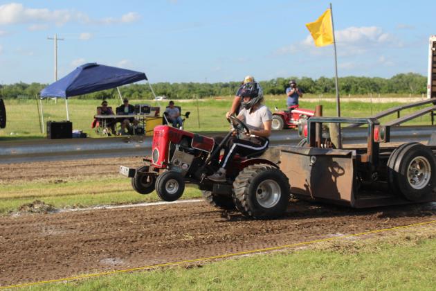 Erin Cash of Glencoe drives "Little Red," belonging to her grandfather Dale Caldwell, in the Modified Class of the Garden Tractor Pull during the 26th Annual Farming Heritage Festival on June 21 at Shawnee Feed Center. She pulled a distance of 133.41 feet.