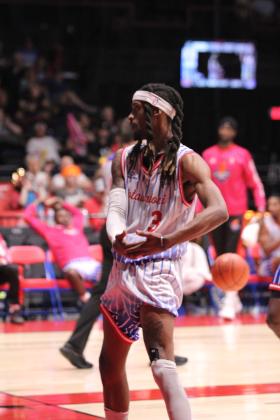 Potawatomi Fire Forward Ricky Artis II pantomimes rocking a baby (representing a trophy) after making a basket in the fourth quarter of the Western Regional Championship on June 15. The Fire beat the Great Falls Electric, 131-113, for their second game, and advance to The Basketball League Finals on Saturday at the FireLake Arena. Natasha Dunagan, Countywide &amp; Sun