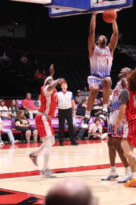 Potawatomi Fire Forward Ke'Tarrious "KT" Boucham swings from the basket for a slam dunk on June 5, in the first game of the Midwest Conference Finals against the Logansport Iron Horses at FireLake Arena. Boucham made 18 points, four rebounds and three assists during that game, according to potawatomifire.com. Natasha Dunagan, Countywide &amp; Sun
