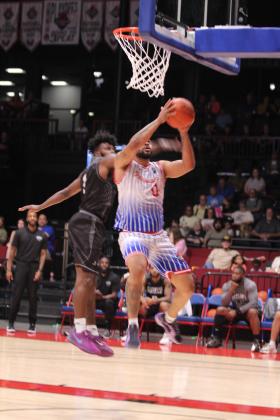 After catching a court-length pass, Potawatomi Fire Guard Deshawn Munson takes it to the hoop during the first quarter of the Central Division Finals Game 2. Munson contributed 20 points, seven rebounds, five assists and four steals, according to potawatomifire.com. The Fire beat the Enid Outlaws, 157-89, in this game and in the first game at Enid, 122-98. They move on to the Midwest Conference Finals today (June 5) and June 7, both days at 7 pm at FireLake Arena.