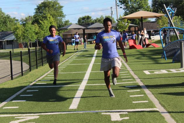 Tecumseh High School sophomores Isaac McAlister and J.J. Thomas race each other in the 40-Yard Dash, sponsored by Shawnee Parks and Recreation, during Fun Day at Kidspace Park on May 30. Fun Day was part of Health Week, which is sponsored by the Avedis Foundation.