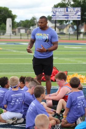 Shamiel Gary, a former NFL player originally from Tulsa, speaks to more than 40 elementary students at his first of two football clinics at Jim Thorpe Stadium on May 29.