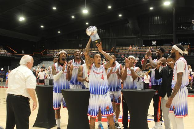 Chuck Guy holds high the Western Regional Championship trophy.