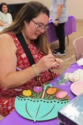 Jocelin Lindholm of Tecumseh works on painting her door sign project at the "Paint Together" event at Shawnee Public Library on June 10. The painting instructor who was scheduled to lead the class was not available, so library staff had to improvise. Visit the Pioneer Library Systems website to see a full calendar of summer programs.