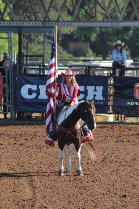 Rodeo Royalty presents the US flag.