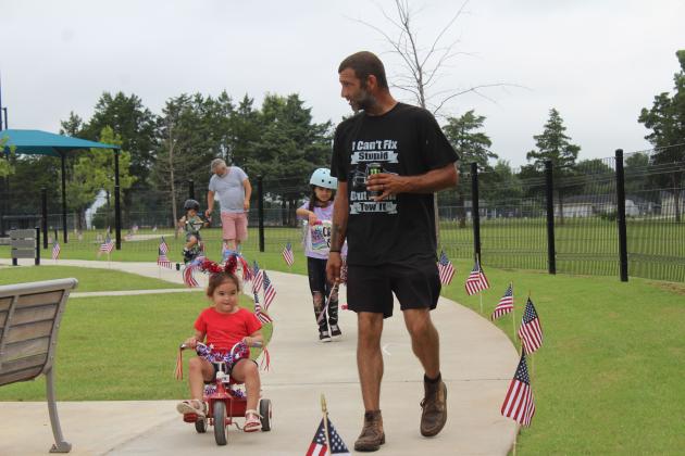Ty Burnett walks with his daughter, Charlie Burnett, 3, both of Norman, during Freedom Fest at Kidspace Park on July 5. Hosted by Shawnee Parks and Recreation and Pottawatomie Go, they held a kids' parade and sidewalk chalk art contest.