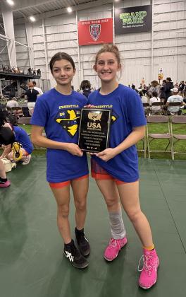 Lizzy Palma-Hernandez and Kylei Gokey, both of Tecumseh, pose with the "2025 16U Women Dual National Championships Women's Freestyle Consolation Team Champion" plaque during the USAW National Duals in Westfield, IN, in June. This put the team at ninth in the U.S. overall, said Gokey's mother, Kaitlin. Photo provided