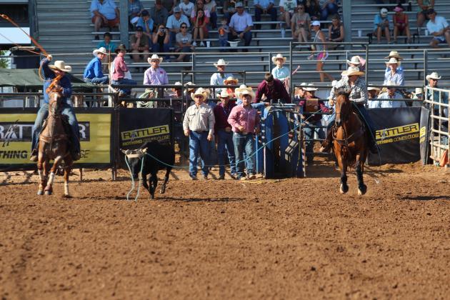 Rowdy John Pino of McLoud, right, and Coy Denny of Red Oak, OK, begin their team roping run in the second go-round at the IFYR on the morning of July 10.