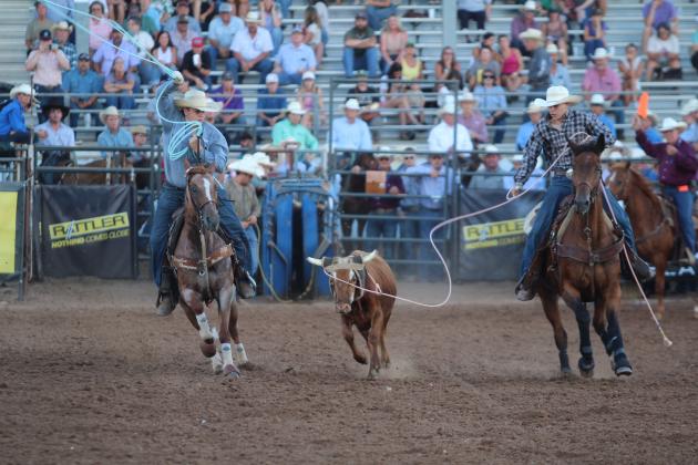 Rowdy John Pino of McLoud, right, catches the steer's head as Coy Denny of Red Oak aims for the feet in Team Roping during the International Finals Youth Rodeo on the evening of July 7.