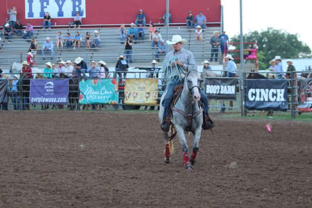 Braxton Ogle of McLoud gathers up his lasso after competing in Team Roping with Colton Thomason of Henryetta during the International Finals Youth Rodeo on the evening of July 7.