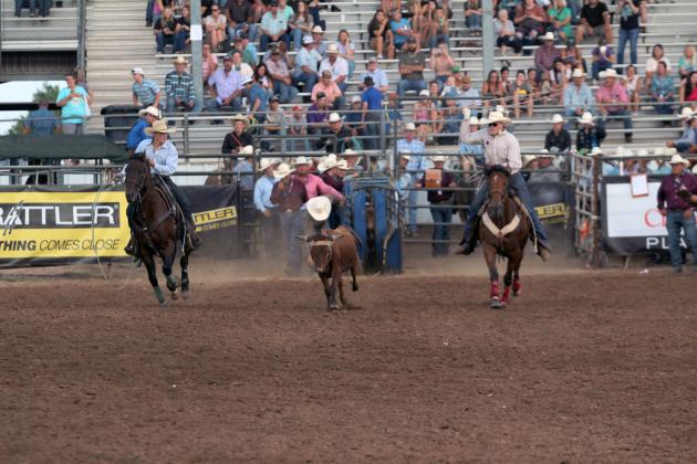 Tim Ortiz of Maud and Landen Youngblood of Shawnee compete in Team Roping during the International Finals Youth Rodeo on the evening of July 7.