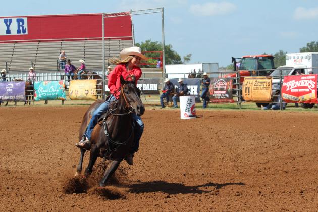 Sydney Johnson of Tecumseh wears a smile as she nears the end of her barrel racing run during the 33rd Annual IFYR, held at the Heart of Oklahoma Expo Center on the morning of July 8.