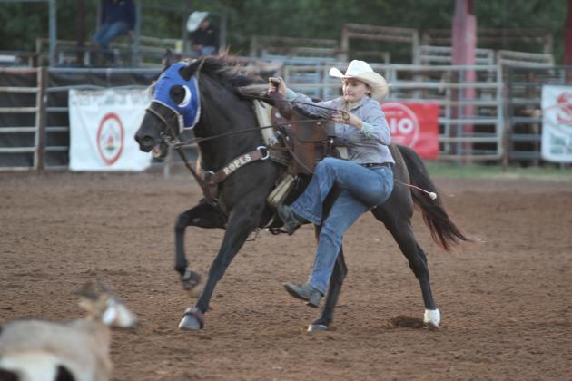 Emma Hankins of Willard, MO, dismounts to tie a goat at the International Finals Youth Rodeo, held at the Heart of Oklahoma Expo Center on the evening of July 8.