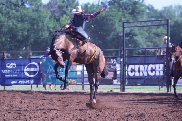 Cole Brooks of Rockmart, GA, hangs on for the saddle bronc ride during the 33rd Annual IFYR, held at the Heart of Oklahoma Expo Center on the morning of July 8.