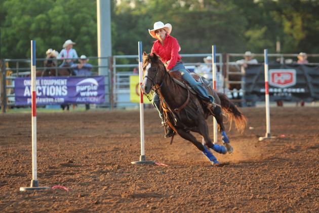 Bella Branham of Tecumseh steers between the poles at the International Finals Youth Rodeo, held at the Heart of Oklahoma Expo Center on the evening of July 9.