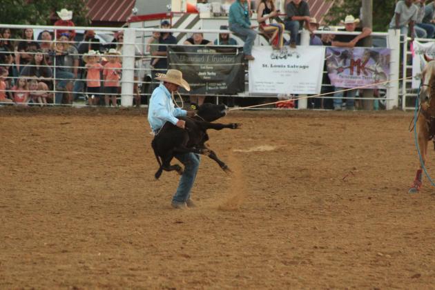 Blaze Carter of Seminole flips his calf before tying his feet in 10.5 seconds during the 79th Annual Maud Roundup Rodeo on July 19.