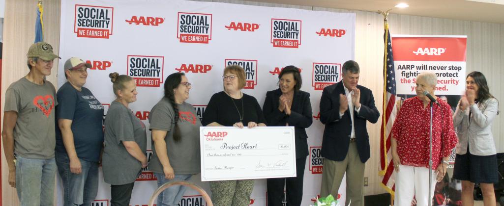 AARP Oklahoma presents a $1,000 check to Project HEART in celebration of the 90th Anniversary of Social Security at the Tecumseh Golden Age Center on Aug. 12. A $1,000 check was also given to the Tecumseh Chamber of Commerce. Shown, from left, are Project HEART Tecumseh Site Staff: Gary Terry, custodian; Heather Hitchcock, head cook; Talia Hammons, cook; and Karissa Marshall, site manager; Theresa Beverage, Mashell Sourjohn, Sean Voskuhl, Chris Harden and U.S. Rep. Stephanie Bice.