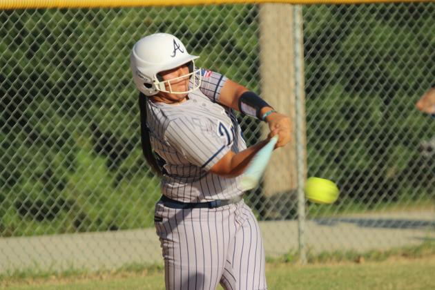Asher sophomore Raina Timms smacks a single during the home game against Moss.