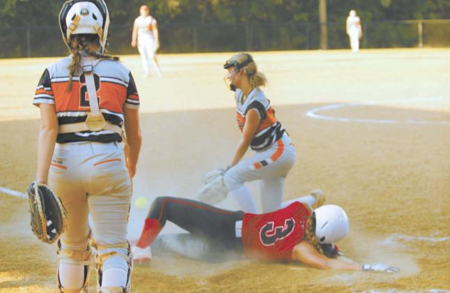 Macomb junior Deja Givens dives across home as Maud senior and pitcher Kylee Collins runs up to tag her during the fast pitch game at Maud on Aug. 8. Also shown is Maud junior and catcher Mariah Burkhalter. Macomb won, 19-6. Natasha Dunagan, Countywide &amp; Sun
