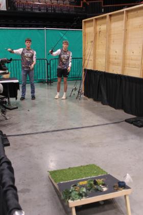Braxton Shelton and Clayton Shelton practice casting onto a cornhole board during the Outdoor Nation Expo on Aug. 9. The Shelton brothers, with their father Kenny as boat captain, are one of several teams on the Tecumseh High School Fishing Team. They taught several children who were new to fishing how to cast during the ONE.
